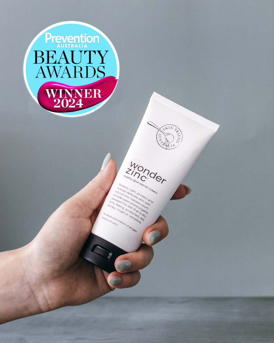 Hand holding a tube of 'wonder zinc' with Prevention Beauty Awards 2024 logo on a gray background