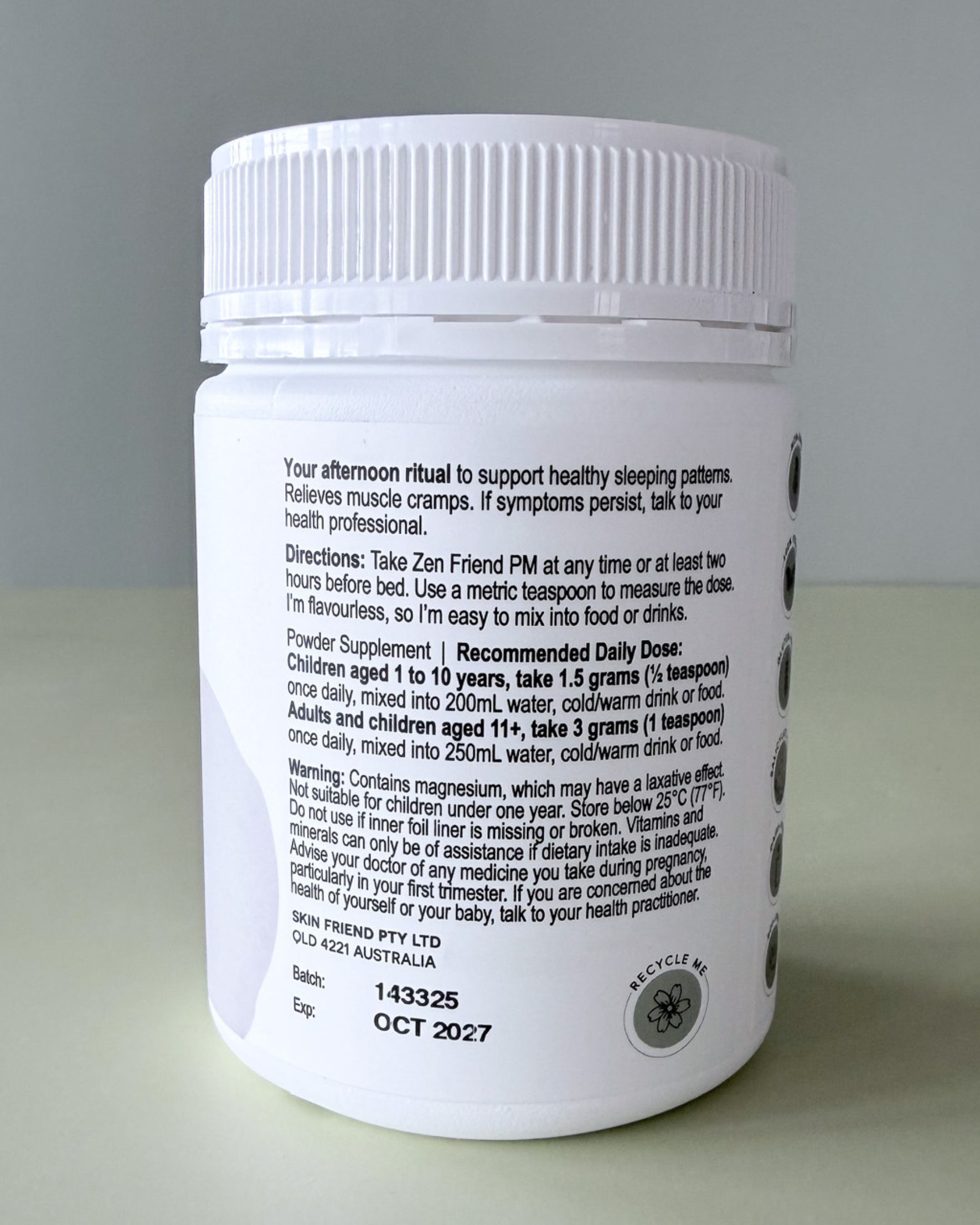 White supplement container with black text on a gray background