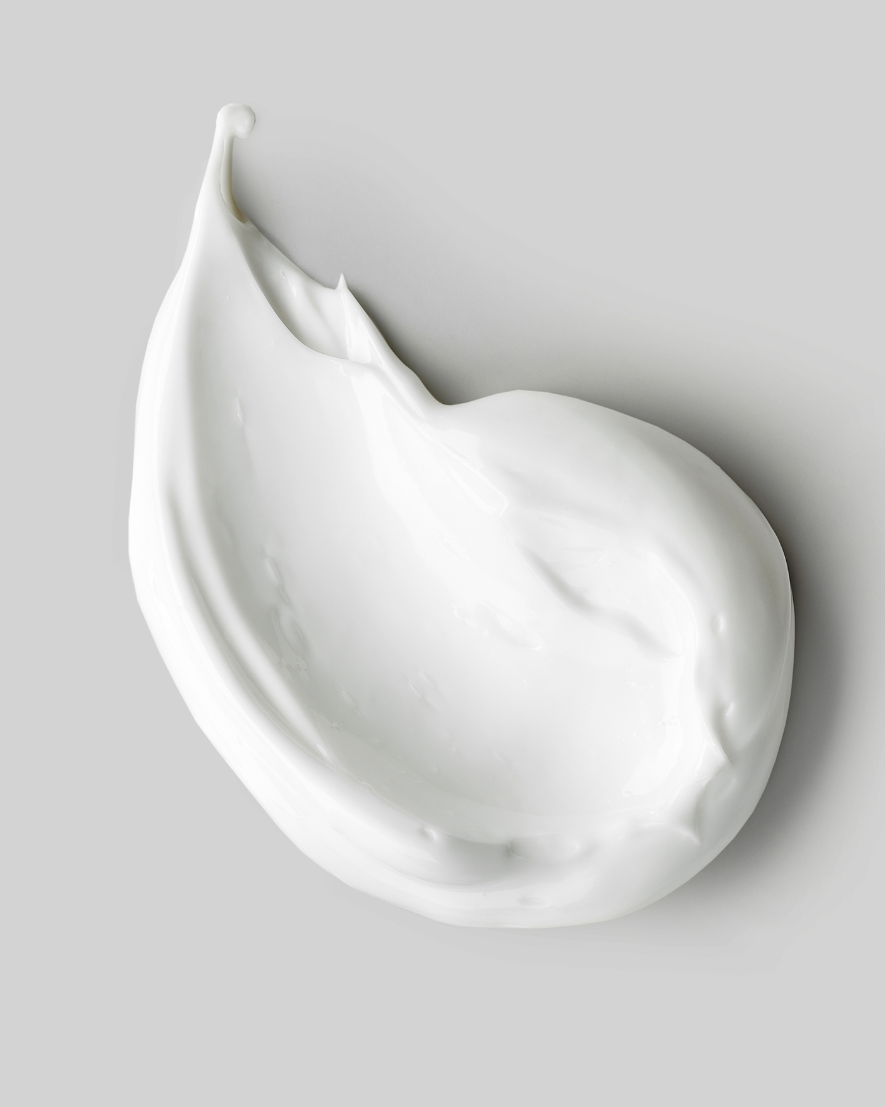 White cream smear on a gray background